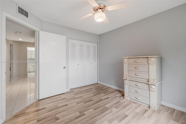 6698 N 10th Ave N Unit 218, Lake Worth, FL 33467 - unfurnished bedroom with baseboards, a closet, light wood-style flooring, and visible vents