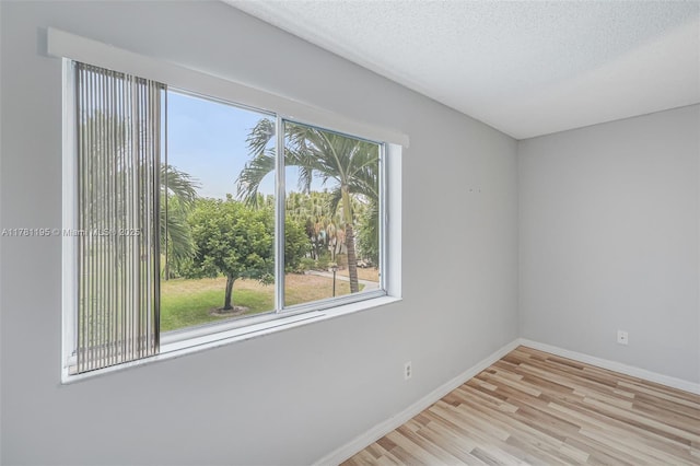 6698 N 10th Ave N Unit 218, Lake Worth, FL 33467 - spare room with a textured ceiling, baseboards, and light wood-style floors