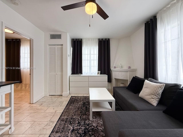 1526 Pennsylvania Ave Unit 20, Miami Beach, FL 33139 - living area featuring a ceiling fan, baseboards, a healthy amount of sunlight, and visible vents