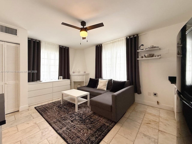 1526 Pennsylvania Ave Unit 20, Miami Beach, FL 33139 - living room with ceiling fan, baseboards, arched walkways, and visible vents
