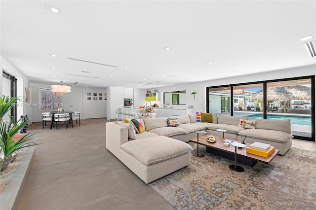 2020 NE 121st Rd, North Miami, FL 33181 - living room featuring finished concrete flooring and recessed lighting