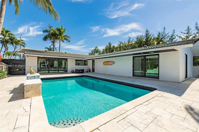 2020 NE 121st Rd, North Miami, FL 33181 - rear view of property with stucco siding and a patio