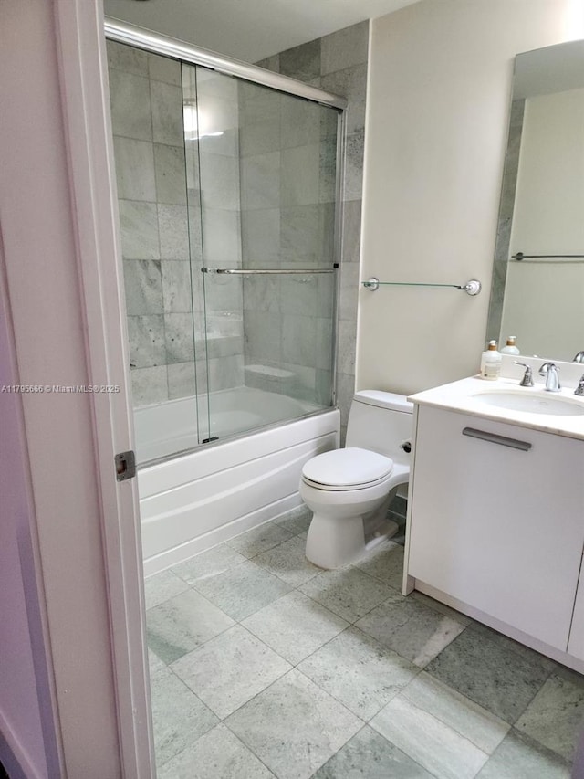 full bathroom with vanity, toilet, and enclosed tub / shower combo