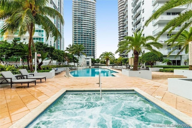 pool featuring a patio and a community hot tub