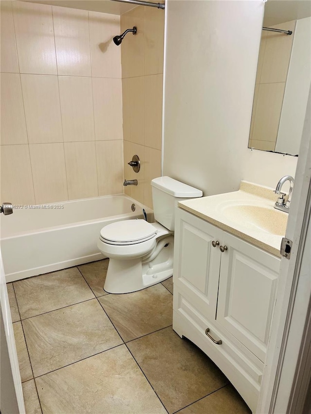 bathroom featuring toilet, tile patterned floors, vanity, and shower / tub combination