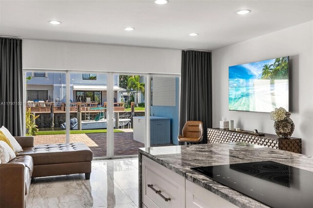 living room featuring marble finish floor and recessed lighting