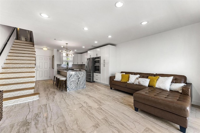 living room featuring stairway, marble finish floor, and recessed lighting