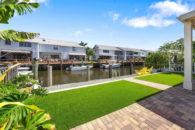 exterior space featuring a water view, a yard, and a residential view