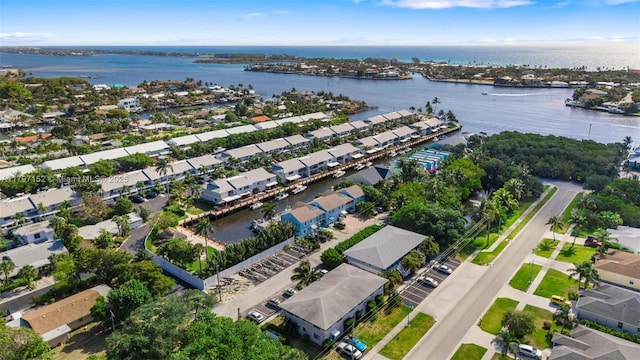 birds eye view of property with a water view and a residential view