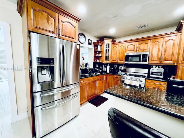 1245 SW 85th Ave, Miami, FL 33144 - kitchen with appliances with stainless steel finishes, brown cabinets, glass insert cabinets, a sink, and light tile patterned floors