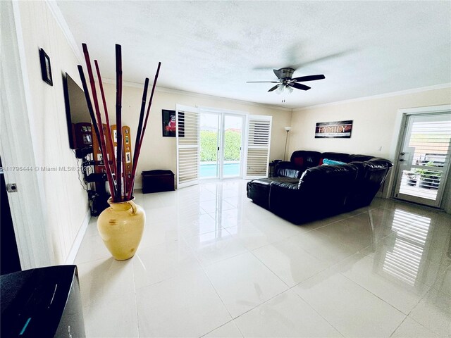 1245 SW 85th Ave, Miami, FL 33144 - living room with ornamental molding, ceiling fan, light tile patterned floors, and a textured ceiling