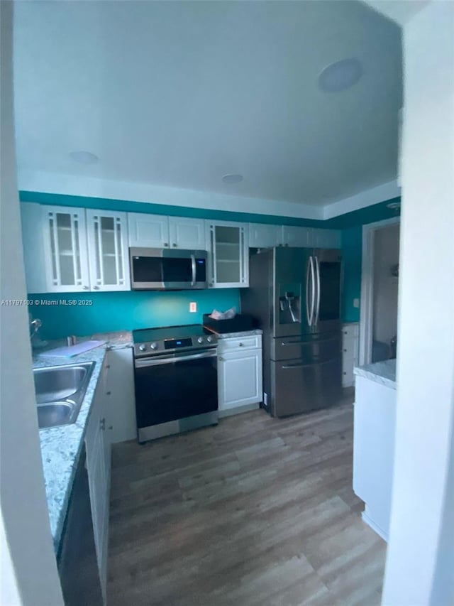 2115 NE 44th St, Lighthouse Point, FL 33064 - kitchen with stainless steel appliances, white cabinets, and glass insert cabinets