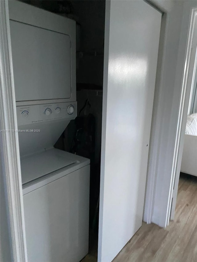 2115 NE 44th St, Lighthouse Point, FL 33064 - clothes washing area with stacked washer / dryer and light wood-type flooring