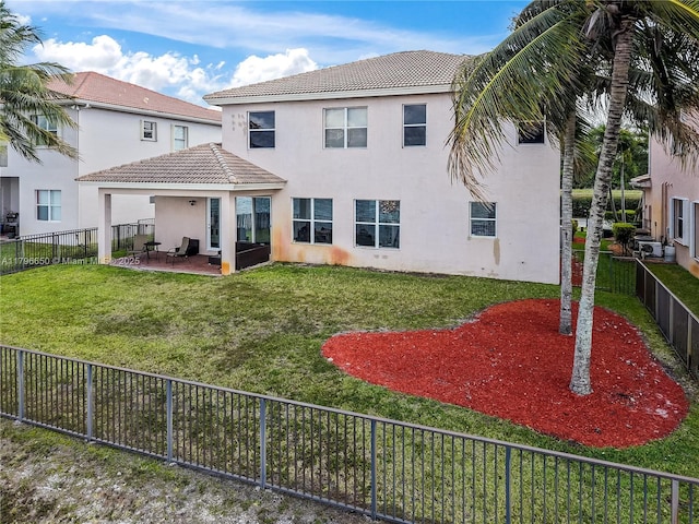 17739 SW 54th St, Miramar, FL 33029 - rear view of property featuring a tiled roof, stucco siding, a lawn, and a patio