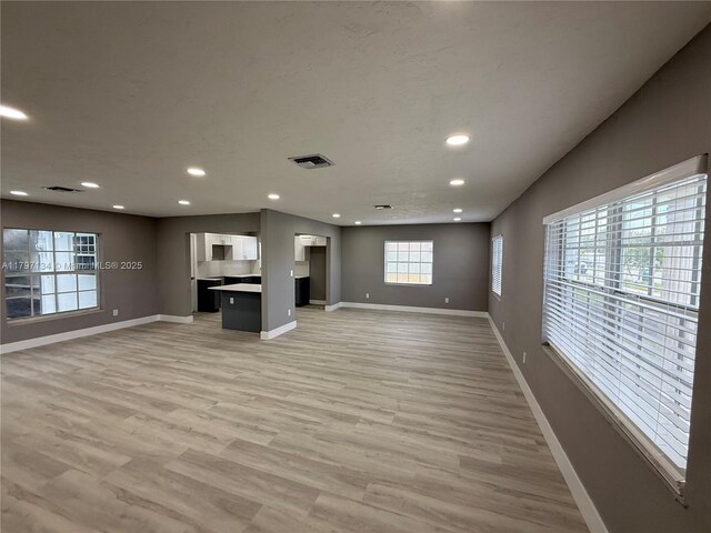 20570 NW 1st Ct, Miami Gardens, FL 33169 - unfurnished living room featuring baseboards, recessed lighting, and light wood-type flooring
