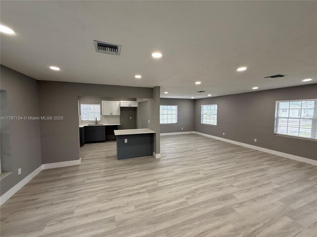 20570 NW 1st Ct, Miami Gardens, FL 33169 - kitchen with a sink, open floor plan, baseboards, and visible vents