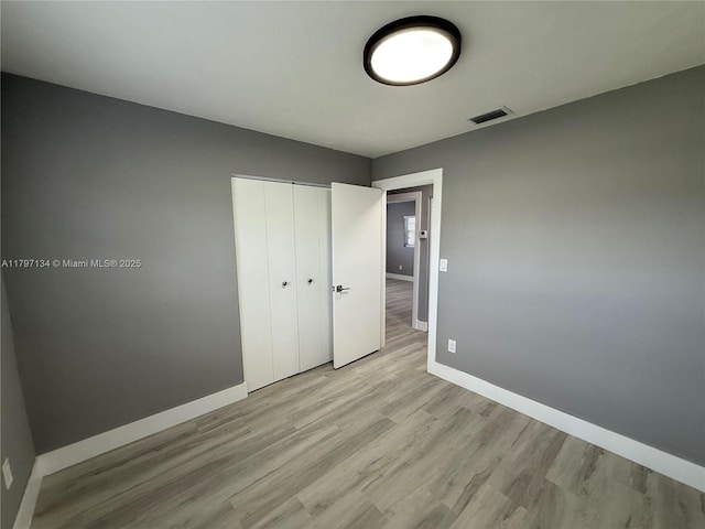 20570 NW 1st Ct, Miami Gardens, FL 33169 - unfurnished bedroom featuring a closet, wood finished floors, visible vents, and baseboards
