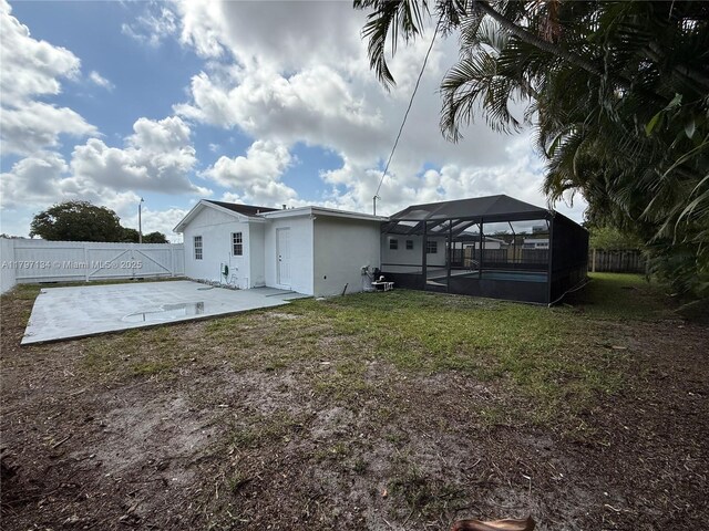 20570 NW 1st Ct, Miami Gardens, FL 33169 - back of house with a patio area, a pool, stucco siding, and glass enclosure