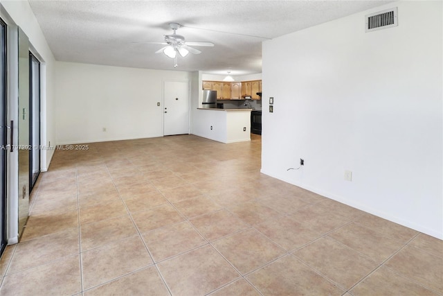 unfurnished living room with baseboards, ceiling fan, visible vents, and light tile patterned flooring