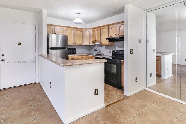 kitchen with light tile patterned floors, black appliances, under cabinet range hood, and a sink