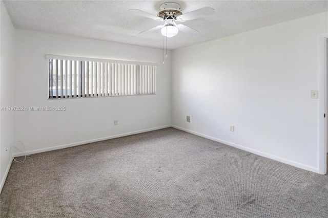 carpeted spare room with a textured ceiling, baseboards, and ceiling fan