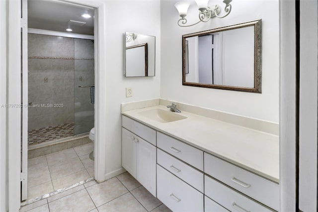 full bath featuring toilet, a stall shower, tile patterned floors, baseboards, and vanity