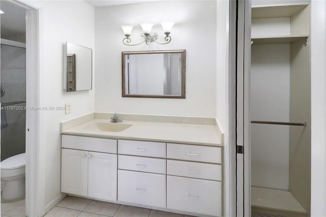 full bath with vanity, toilet, a shower stall, and tile patterned floors