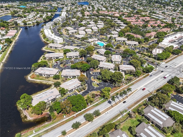 drone / aerial view with a water view and a residential view