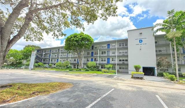 view of building exterior with uncovered parking