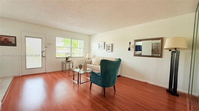 13450 SW 3rd St Unit 308D, Pembroke Pines, FL 33027 - sitting room with a textured ceiling, baseboards, and wood finished floors