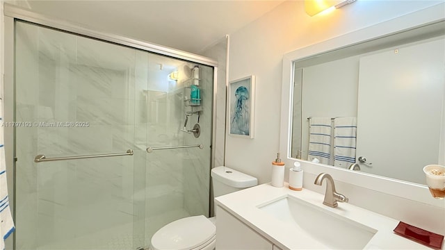 full bath featuring vanity, toilet, and a marble finish shower
