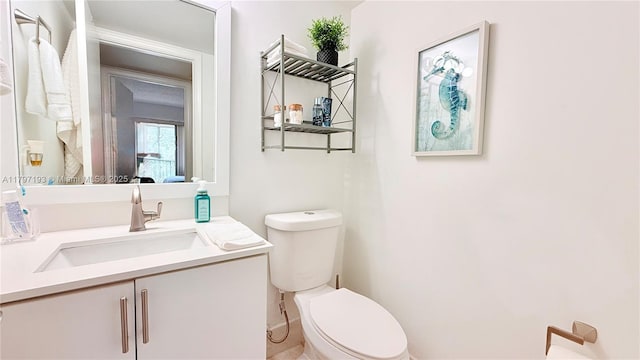 half bath featuring toilet and vanity