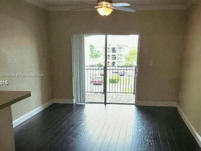 unfurnished room with baseboards, hardwood / wood-style floors, crown molding, and ceiling fan
