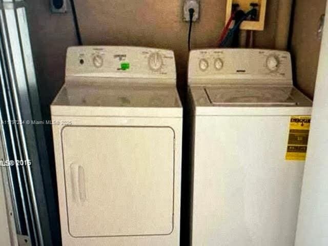 laundry area with washer and clothes dryer and laundry area