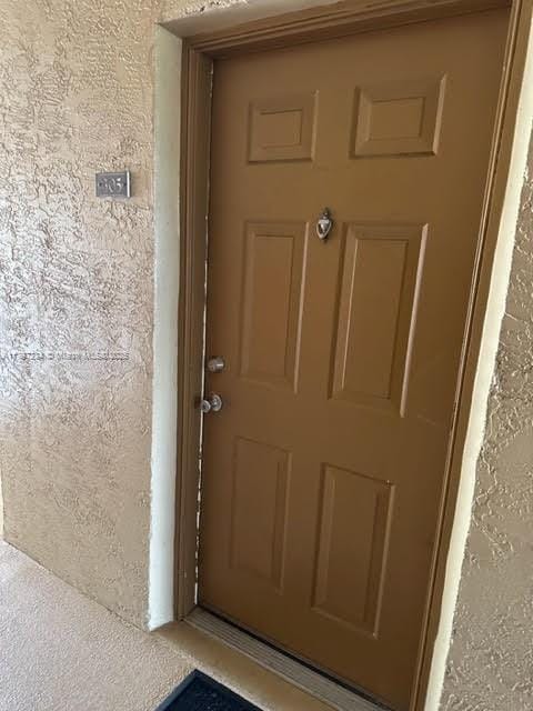 doorway to property with stucco siding