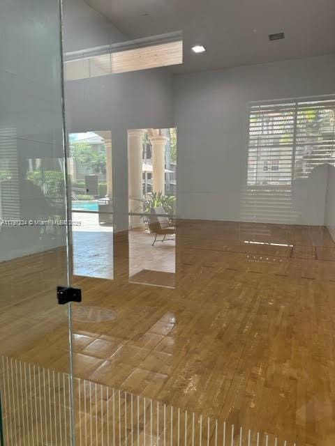 interior space with a towering ceiling and wood finished floors