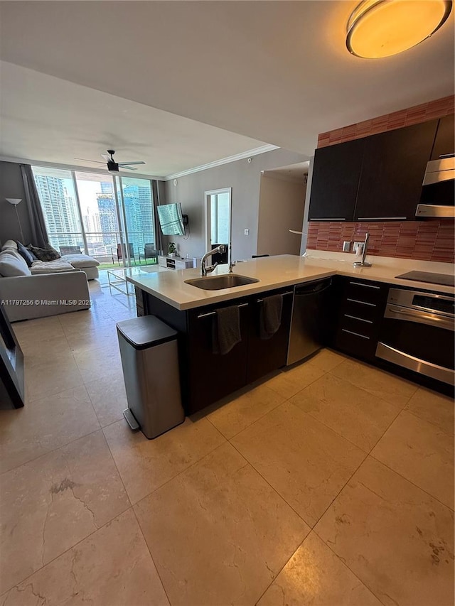 kitchen with stainless steel oven, a sink, light countertops, open floor plan, and dishwashing machine