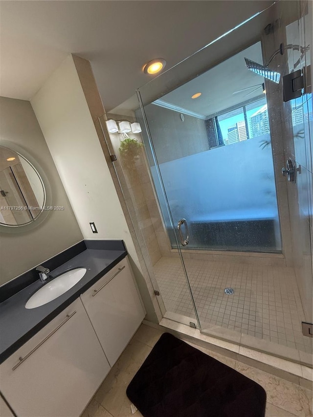 bathroom featuring a stall shower, vanity, and recessed lighting