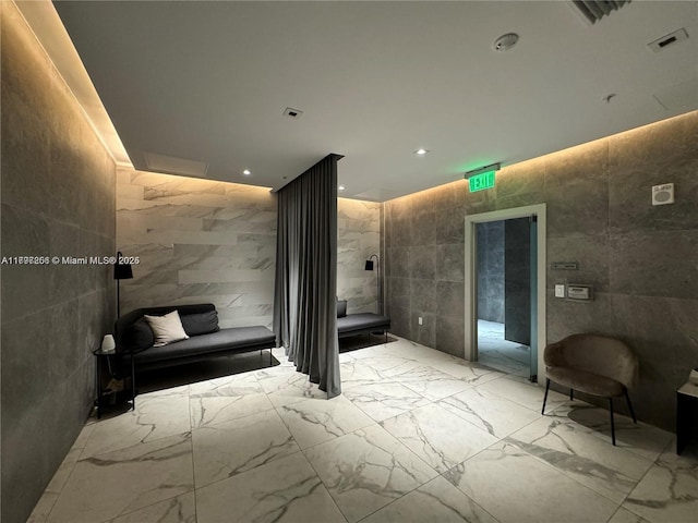 building lobby with tile walls and recessed lighting