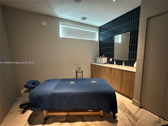 bedroom featuring tile walls