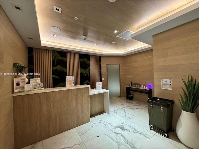 reception featuring wood walls and wood ceiling
