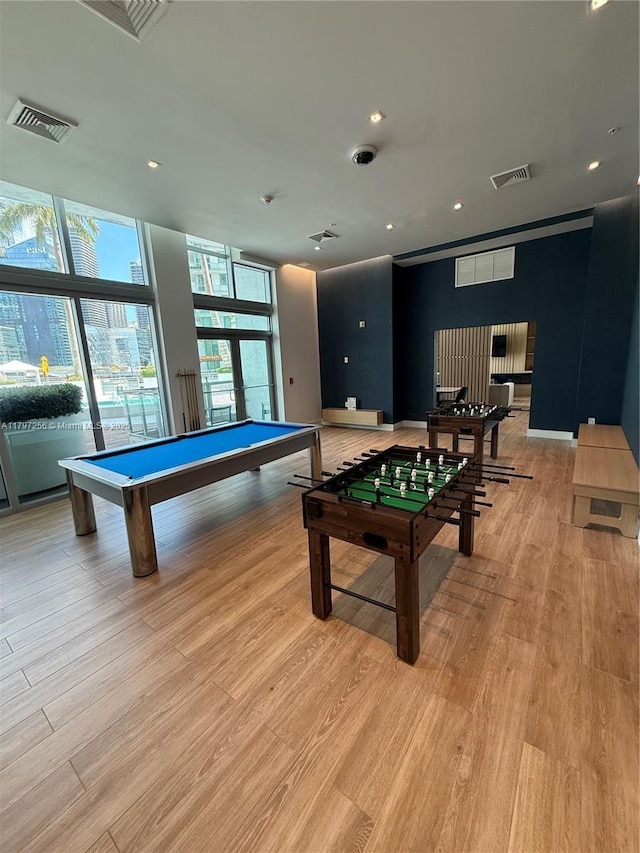 recreation room featuring pool table, light wood-style floors, a wall of windows, and recessed lighting