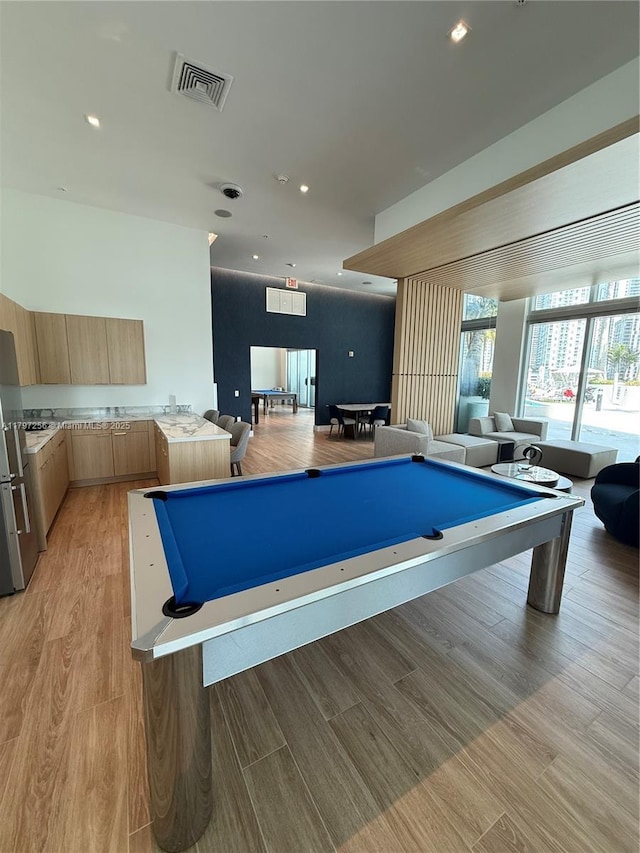 game room featuring billiards, light wood finished floors, and recessed lighting