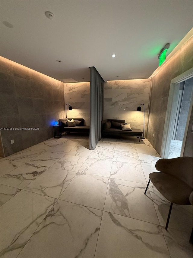 hallway featuring light marble finish flooring and recessed lighting