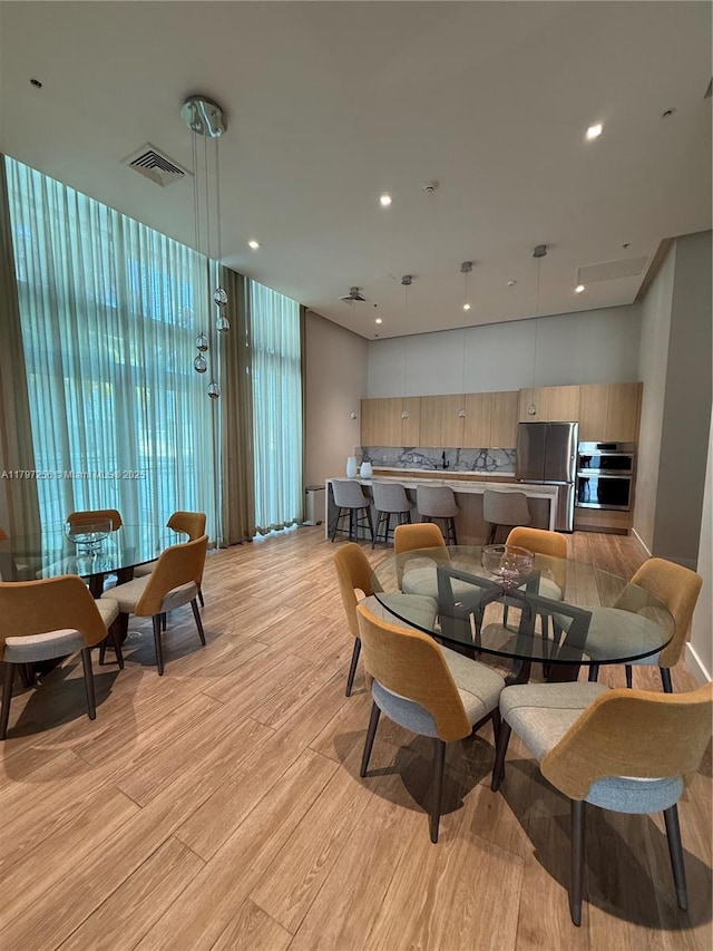dining space featuring light wood-style floors and recessed lighting
