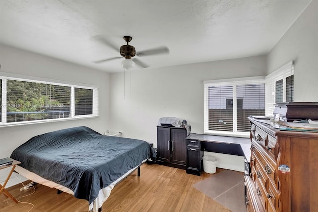bedroom with light wood finished floors and a ceiling fan