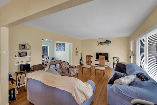 living room with wood finished floors and a healthy amount of sunlight