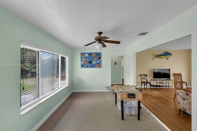 recreation room with ceiling fan, baseboards, and visible vents