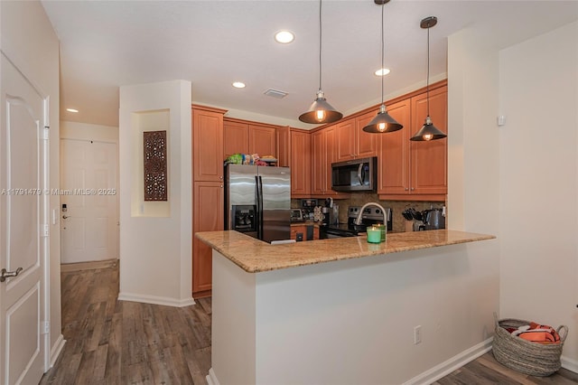 2750 SW 81st Ave Unit 1202, Miramar, FL 33025 - kitchen with appliances with stainless steel finishes, a peninsula, wood finished floors, backsplash, and baseboards