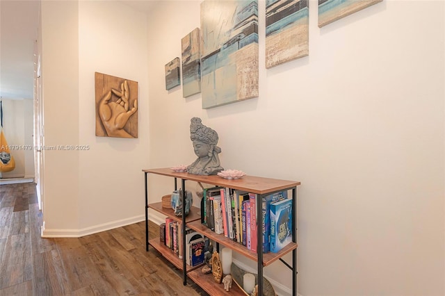 hall with wood finished floors and baseboards